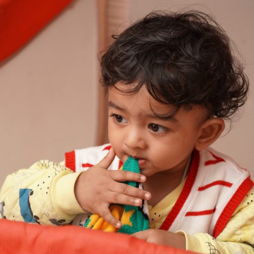 an-indian-baby-boy-biting-a-cloth-in-his-playpen-2025-10-16-11-21-50-utc