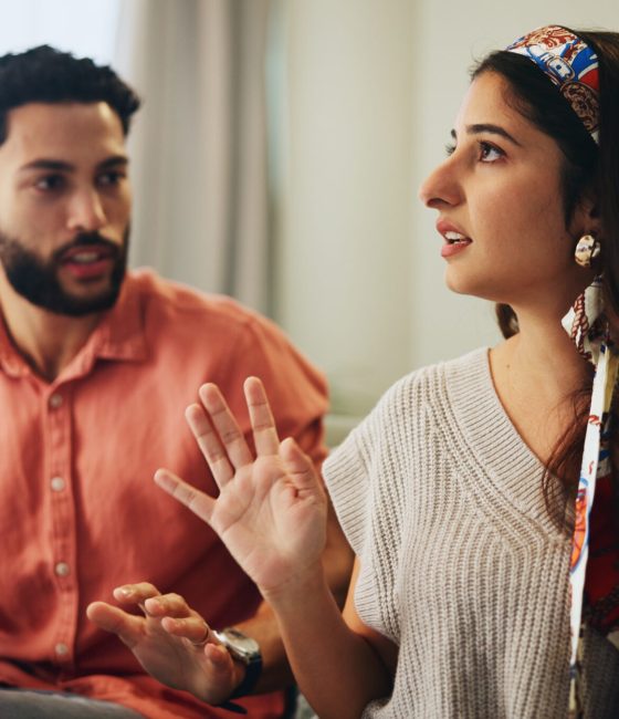 Couple, living room and dispute with anxiety, stress and drama at home or apartment. Frustrated, wo.